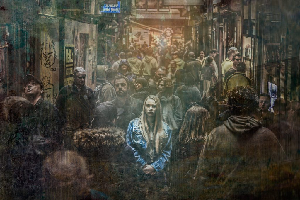 dull crowd with glowing woman standing out