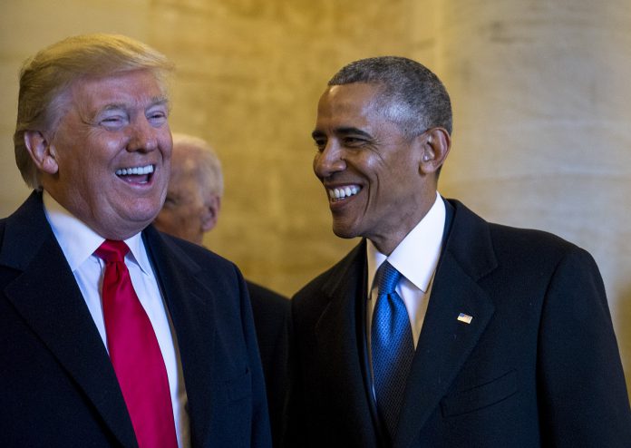 Presidents Obama and Trump laughing together